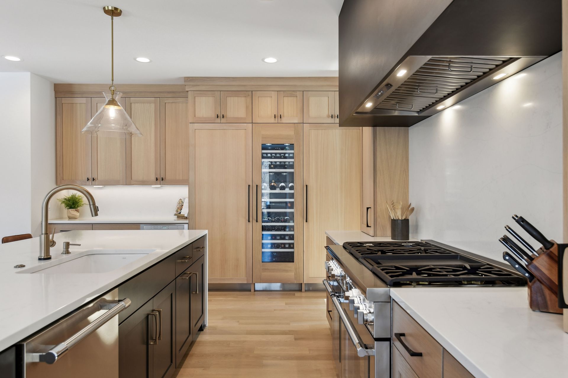 Gourmet kitchen with wine fridge, gas range and oak cabinetry
