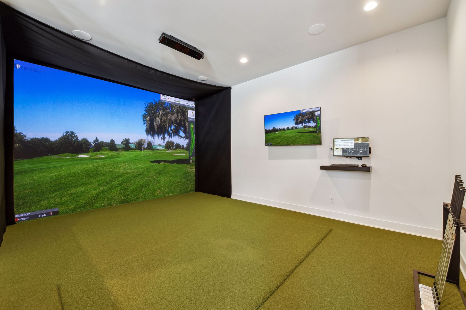 Custom home golf simulator room with projection screen and club storage